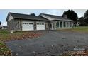 Stone house with a two-car garage and large yard at 2022 Friendship Church Rd, Taylorsville, NC 28681