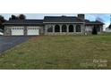 Stone house with a two-car garage and large yard at 2022 Friendship Church Rd, Taylorsville, NC 28681