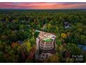 Breathtaking aerial view of estate nestled amidst lush greenery with expansive backyard and putting green at 2723 Providence Pine Ln, Charlotte, NC 28270