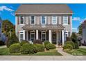 Two-story house with gray siding, shutters, and a front porch at 376 Delburg St, Davidson, NC 28036