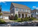 Two-story house with gray siding, shutters, and a front porch at 376 Delburg St, Davidson, NC 28036