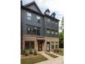 Three-story townhouse with gray siding and brick accents at 412 Tristram Ln, Charlotte, NC 28205