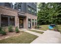 Townhouse patio with walkway, grill, and blue chair at 412 Tristram Ln, Charlotte, NC 28205