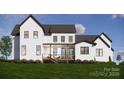 Back exterior view of a two-story home showcasing a deck and landscaping at 1935 Weddington Rd # A, Matthews, NC 28105