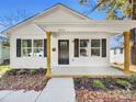 White house with a covered porch and landscaping at 305 Gooch St, Lancaster, SC 29720