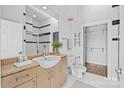 Well-lit bathroom featuring a large sink, vanity, and a walk-in shower with modern fixtures at 708 N Davidson St, Charlotte, NC 28202