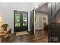 Elegant entryway with black double doors and a barn door at 128 Archbell Point Ln, Mooresville, NC 28117