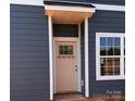 Exterior shot of a home's entrance with blue siding and a covered doorway at 4049 Port Richmond Ave # 11, Gastonia, NC 28056