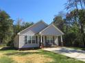 Charming single-story home featuring a covered front porch, tidy lawn, and a private, wooded perimeter at 4986 6Th Sw St, Catawba, NC 28609