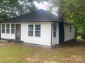 Exterior angle of home with black trim and white siding at 7608 Kershaw Camden Hwy, Kershaw, SC 29067