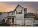 Charming two-story home features a two car garage, blue shutters and vinyl siding at 1176 Whitehall Hill Rd, York, SC 29745