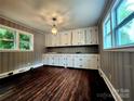 Bright dining room featuring beautiful wood floors and elegant built-in cabinetry at 3337 Eastway Dr, Charlotte, NC 28205