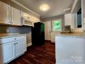 Well-lit kitchen features white cabinets, modern appliances, and hardwood floors at 3337 Eastway Dr, Charlotte, NC 28205