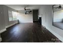 Bright living room showcasing a decorative fireplace, ceiling fan, and light walls at 3337 Eastway Dr, Charlotte, NC 28205