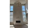 Bright living room features a modern fireplace, large windows and an elegant chandelier at 4374 Morning Mist Dr # 25, Sherrills Ford, NC 28673