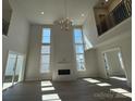 A contemporary living room featuring a fireplace, big windows and hardwood flooring at 4374 Morning Mist Dr # 25, Sherrills Ford, NC 28673