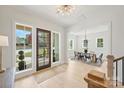 Bright foyer with hardwood floors, chandelier, and view into the dining room at 571 Lyttleton Dr, Charlotte, NC 28211