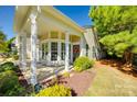 Charming home with covered porch, white columns, bay window, and lush landscaping; perfect for relaxing outdoors at 4006 Trinity Ct, Indian Land, SC 29707