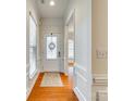 Bright foyer with hardwood floors, white trim, a decorative front door, and transom window at 4006 Trinity Ct, Indian Land, SC 29707