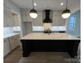 Modern kitchen with a large island, quartz countertops, and black cabinetry at 714 Barrel Aly, Fort Mill, SC 29715