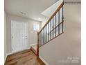 Elegant staircase with a metal railing leading to the upper level of the home at 117 Dorian Pl, Troutman, NC 28166