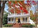 Two-story house with wraparound porch and brick steps, surrounded by autumn leaves at 1360 Barnett Woods, Fort Mill, SC 29708