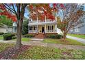 Two-story house with a brick walkway and landscaping; autumn leaves are scattered on the ground at 1360 Barnett Woods, Fort Mill, SC 29708