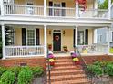 Brick steps leading to a charming front porch with autumn decor at 1360 Barnett Woods, Fort Mill, SC 29708