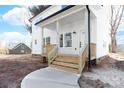 Inviting front porch featuring fresh wood stairs and white columns on a new home at 150 Roxie Ln, Belmont, NC 28012