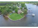 Expansive waterfront property with a lush lawn, private dock, and stunning lake views at 18210 Pompano Pl, Cornelius, NC 28031