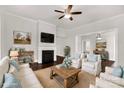 Cozy living room with fireplace, ceiling fan, hardwood floors, and comfortable seating at 305 N White St, Lancaster, SC 29720