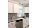 Modern kitchen with white cabinets, granite countertops, and a large window at 5105 Chelsey Ln, Monroe, NC 28110