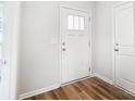 Bright entryway with white door, wood-look flooring, and crisp white walls at 112 Bickett Ave, Gastonia, NC 28052