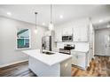 Modern kitchen with white cabinets, stainless steel appliances, and an island at 112 Bickett Ave, Gastonia, NC 28052