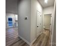 Clean hallway with light walls and wood-look floors at 11933 Cabera Ln, Midland, NC 28107