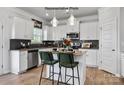 Island kitchen with granite countertops and white cabinets at 11933 Cabera Ln, Midland, NC 28107