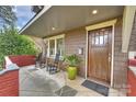 Inviting front porch with rocking chairs and a large potted plant at 2526 Normandy Rd, Charlotte, NC 28209