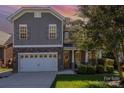 Two-story home with gray siding, stone accents, and a two-car garage at 2844 Georgia Ave, Charlotte, NC 28205