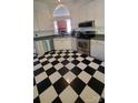 Bright kitchen with black and white checkered flooring and modern stainless steel appliances at 4000 Wilson Ln, Charlotte, NC 28206