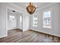 Bright dining room featuring a decorative chandelier and hardwood floors at 613 Hops Aly, Fort Mill, SC 29715