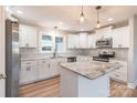 Modern kitchen featuring white cabinets, stainless steel appliances, and a marble island at 118 Alf Hoover Rd, Lincolnton, NC 28092