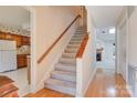 Entryway showcasing staircase, wood flooring, kitchen glimpse and lots of natural light in a well-kept home at 1652 12Th Ne St, Hickory, NC 28601