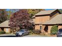 Charming home exterior featuring well-maintained landscaping and a driveway with parked car at 1652 12Th Ne St, Hickory, NC 28601