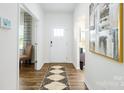 Inviting foyer with hardwood floors, a decorative rug, and ample natural light at 3880 Maxwell Henry Nw Ln, Conover, NC 28613