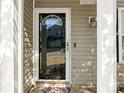 Close up of the front door with glass and sidelights, and decorative door hardware at 1623 Forest Stream Ct, Charlotte, NC 28213