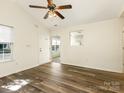 View of the living room showcasing new flooring, a ceiling fan, and an open layout to the kitchen at 1623 Forest Stream Ct, Charlotte, NC 28213