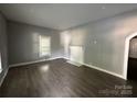 Bright living room with a decorative fireplace, neutral wall colors, and sleek floors at 322 S Liberty St, Gastonia, NC 28052