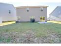 Back exterior featuring a well kept lawn and sliding glass door at 4342 Allenby Pl, Monroe, NC 28110