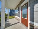 Covered front porch with stone accents and wood-look siding and trim at 4342 Allenby Pl, Monroe, NC 28110