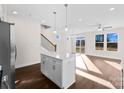 Open concept kitchen with island and stainless steel appliances at 8603 Mcclure Cir, Charlotte, NC 28216